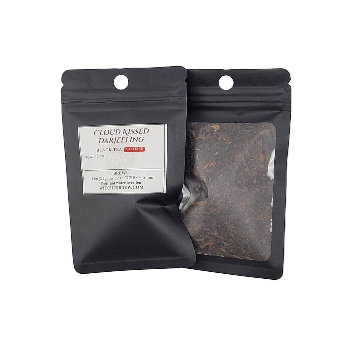 Two black tea packages on a light gray background